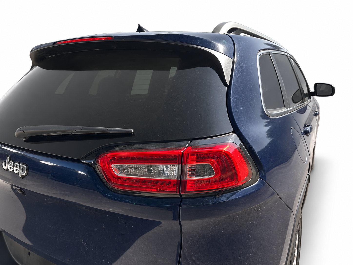 2016 Jeep Cherokee Limited rear-quarter view on white background
